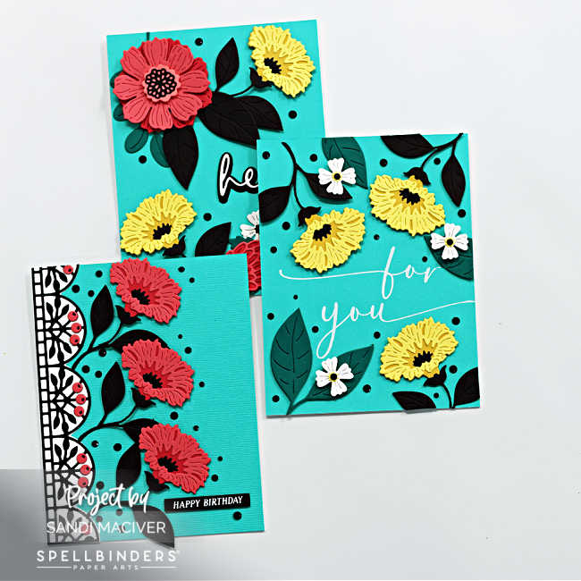 three hand made cards with turquoise backgrounds and pink and yellow flowers with black leaves