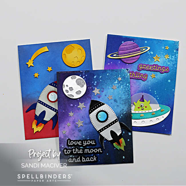 three hand made die cut cards with space ship and UFO's with a Distress Oxide Ink Sprays background created to look like the Galaxy and the Milky Way