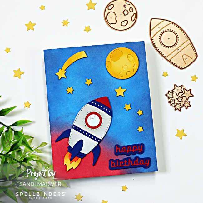 die cut rocket ship atop a blue and red ink blended galaxy background.