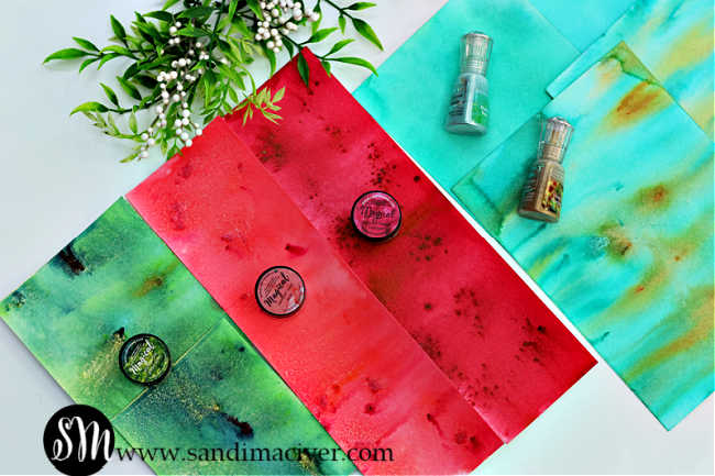 hand made papers using lindy's magicals and Nuvo shimmer Powders in greens and reds