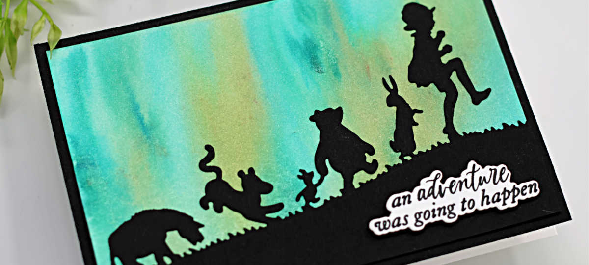 hand made card with a green and gold sky and a silhouette of winnie the pooh and friends holding hands off on an adventure