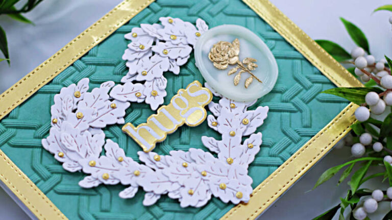 hand made mint colored valentine card with a gold frame, a white heart created from small white leaves, with gold berries, a gold sentiment in the center and a white wax seal with a gold rose in the center