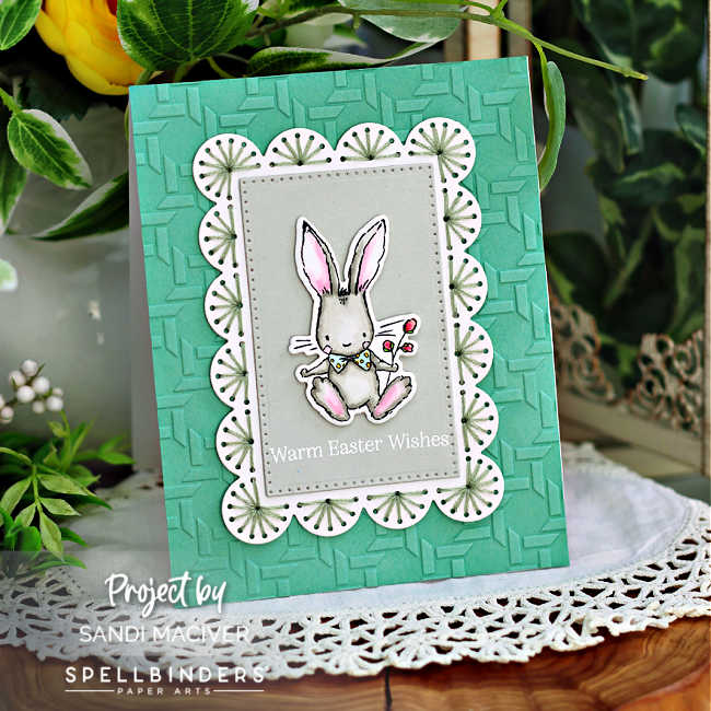 handmade Easter card with a mint colored embossed background, a white scalloped stitched frame and a gray colored bunny