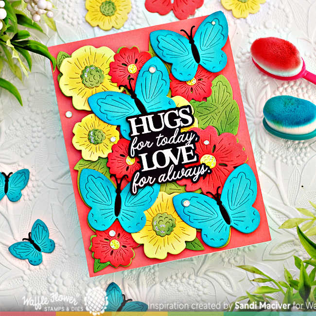 hand made card with die cut yellow and peach flowers and turquoise butterflies with a black and white center sentiment