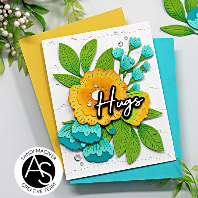 yellow, teal and green floral die cut card with a black and white die cut sentiment and clear rhinestone embellishments