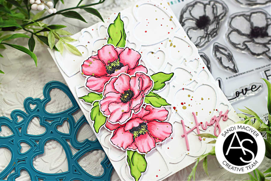 hand made support card with a white background and heart die cut overlay, pink hand colored flowers down the left side with green leaves and a pink die cut hugs sentiment