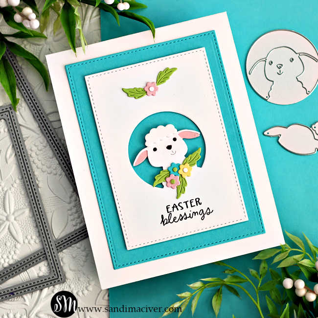 hand made card in teal and white with a cute die cut white lamb surrounded by spring flowers.