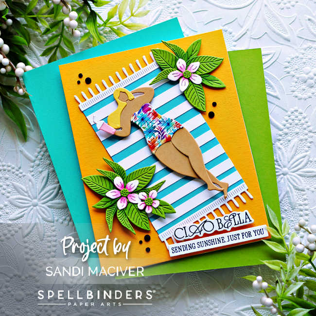 Handmade summer card featuring a die-cut sunbather in a floral swimsuit lounging on a striped beach towel, created with the Spellbinders La Dolce Vita collection. Embellished with tropical leaves, pink and white flowers, and the sentiment “Ciao Bella – Sending Sunshine Just For You” on a vibrant yellow card base.