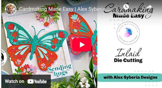 video thumbnail of a Handmade greeting card featuring a colorful die-cut butterfly design in teal, orange, pink, and aqua, accented with floral die cuts and embossed background texture. Sentiment reads “Sending hugs.” Perfect for spring or summer cardmaking inspiration using Alex Syberia Designs Butterfly Bliss collection.