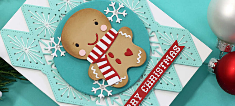 Handmade Christmas card featuring a die-cut gingerbread cookie with rosy cheeks and a red-and-white striped scarf, created using the Spellbinders July Stitched Club of the Month Frosted Stitch and the Caboodle Bonus Die Set of the Month Ginger Sip Die Set. The background showcases a teal stitched snowflake design layered on a white card base. A circular teal panel with white die-cut snowflakes frames the gingerbread figure. A red sentiment strip with a white heat-embossed "Merry Christmas" from the Stay Snuggly Clear Stamp and Die Set of the Month completes the festive design.