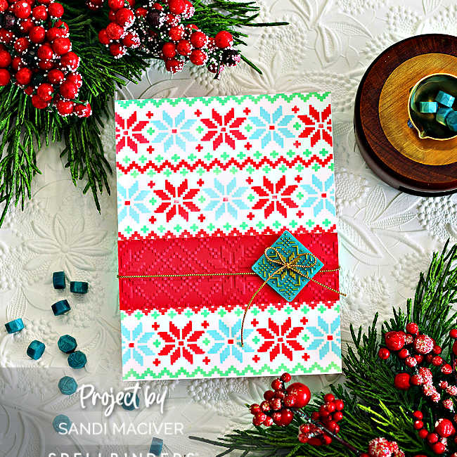 Handmade Christmas card featuring a festive red, teal, and white Nordic sweater pattern created with the Spellbinders Warm and Woven stencil. A bright red center band is wrapped with gold thread and accented with a small teal wax seal with the repeating sweater pattern highlighted in gold tag, 