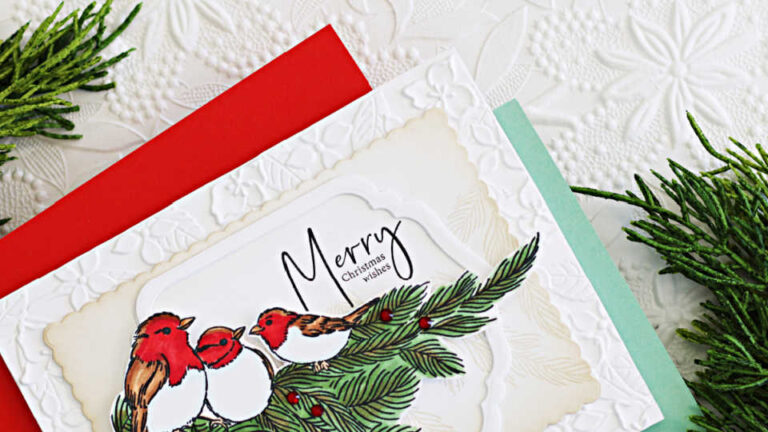 Handmade Christmas card created with the Simon Says Stamp and Penny Black STAMPtember collaboration stamp set. Three red-breasted birds, colored with Copic markers, sit on pine branches accented with red berries. The background is softly ink blended with Latte ink and framed with an embossed white border, finished with the sentiment ‘Merry Christmas Wishes