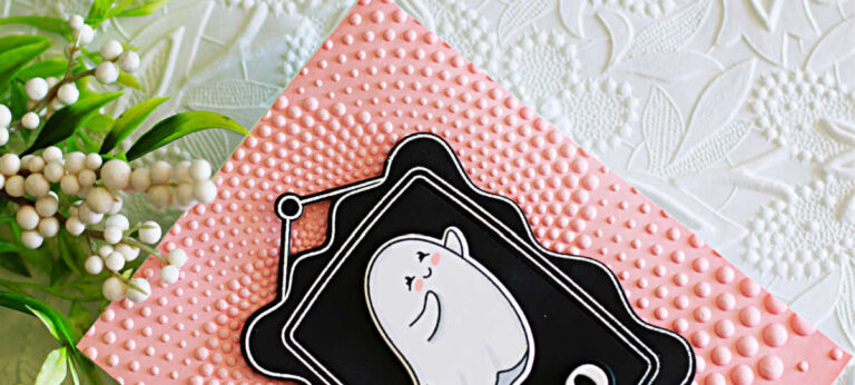 Handmade Halloween card created with the Simon Says Stamp My Boo stamp and die set. The card features a cute copic-colored ghost framed on a black panel with the sentiment “boo.” The background is embossed with the Dotted Spiral embossing folder on soft pink cardstock, adding texture and dimension. Playful ghost and pumpkin accents complete this cheerful Halloween design.
