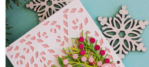 Handmade Christmas card created with the Simon Says Stamp Candy Cane Plate, Ho Ho Holiday Greens dies, and Joy and Cheer sentiment from the Sugar and Spice release. Features a pink die-cut background, layered holiday greens, pink berries, and bold Joy & Cheer sentiment for a festive modern design