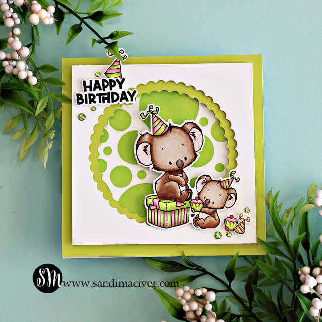 Handmade square birthday card featuring two adorable koalas from the Simon Says Stamp Koala-ty Birthday stamp and die set, part of the Sugar and Spice release. The design includes a bright lime green ink-blended background created with the Mix and Match Circles Stencil and a layered scalloped circle frame die-cut using the Scalloped Circles Nested Die Set. The larger koala sits on a striped gift box while the smaller one holds a cupcake, both wearing colorful party hats. A bold “Happy Birthday” sentiment and green gem embellishments complete the cheerful, playful design by Sandi MacIver.