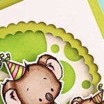 Handmade square birthday card featuring two adorable koalas from the Simon Says Stamp Koala-ty Birthday stamp and die set, part of the Sugar and Spice release. The design includes a bright lime green ink-blended background created with the Mix and Match Circles Stencil and a layered scalloped circle frame die-cut using the Scalloped Circles Nested Die Set. The larger koala sits on a striped gift box while the smaller one holds a cupcake, both wearing colorful party hats. A bold “Happy Birthday” sentiment and green gem embellishments complete the cheerful, playful design by Sandi MacIver.