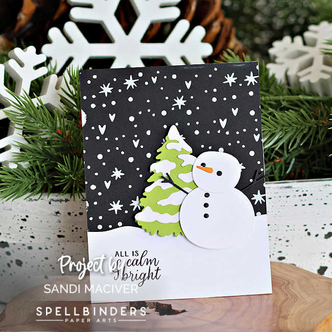 Handmade Christmas card created by Sandi MacIver featuring the Spellbinders October 2025 Small Die of the Month “Snow Day Friends.” The card showcases a layered white die-cut snowman and tree on a snowy black background hot foiled in white with the Magic Wonderland October Glimmer Club plate. The sentiment “All is calm & bright” from the To You and Yours October Clear Stamp and Die Set is stamped on a curved white snowbank. Clean and modern design in classic holiday colors with pops of lime green and red.