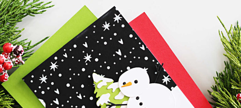 Handmade Christmas card created by Sandi MacIver featuring the Spellbinders October 2025 Small Die of the Month “Snow Day Friends.” The card showcases a layered white die-cut snowman and tree on a snowy black background hot foiled in white with the Magic Wonderland October Glimmer Club plate. The sentiment “All is calm & bright” from the To You and Yours October Clear Stamp and Die Set is stamped on a curved white snowbank. Clean and modern design in classic holiday colors with pops of lime green and red.