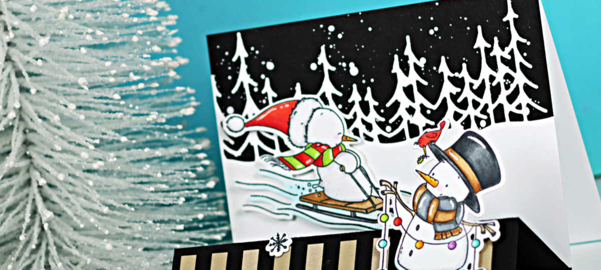 A handmade landscape stair step card featuring winter snowmen created with the Simon Says Stamp Wrapped in Scarves stamp and die set. The background panel shows a snowy forest scene with white die-cut trees against a black sky with white paint splatter resembling snowfall. The front step of the card has a black and kraft striped panel, a large white die-cut snowflake, and a sentiment that reads “Snowman Kisses and Warm Winter Wishes.” One snowman is wrapped in a scarf and sledding, while another stands on the front step holding colorful holiday lights with a small red bird perched on its hat.