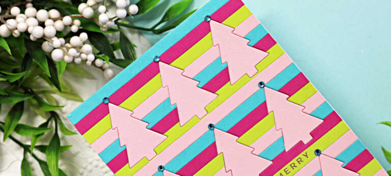 Handmade Christmas card featuring rows of pastel pink Cotton Candy die-cut Christmas trees arranged on a striped background of Peridot, Audrey Blue, Doll Pink, and Cotton Candy cardstock. Each tree is topped with a small aqua gem, and the gold-foiled sentiment “Very Very Merry” is stamped across the center. The card is styled with greenery and white berry accents on a white embossed background and aqua backdrop.