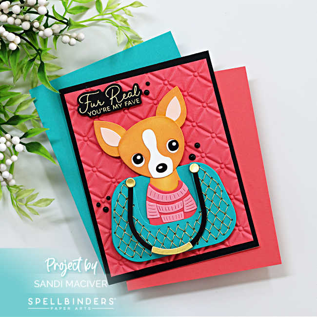 Handmade card featuring a die-cut chihuahua sitting inside a teal quilted Chanel-style purse with gold accents. The dog is wearing a pink sweater, and the background is a deep coral panel embossed with the Spellbinders Petite Tuft 3D Embossing Folder. The sentiment in gold reads “Fur Real, You’re My Fave.” Card designed by Sandi MacIver using Spellbinders November Club Kits.