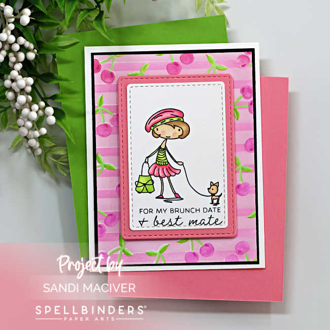 Handmade card featuring a stamped girl walking a small dog, colored in pink and green tones, from the Spellbinders Go-To Girl stamp set. The background is inked using the Cherry Chic layered stencil in pink with green stems on soft pink stripes. The sentiment reads “For my brunch date + best mate.” Card designed by Sandi MacIver using Spellbinders November Club Kits.