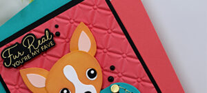 Handmade card featuring a die-cut chihuahua sitting inside a teal quilted Chanel-style purse with gold accents. The dog is wearing a pink sweater, and the background is a deep coral panel embossed with the Spellbinders Petite Tuft 3D Embossing Folder. The sentiment in gold reads “Fur Real, You’re My Fave.” Card designed by Sandi MacIver using Spellbinders November Club Kits.