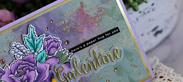 Handmade Galentine’s Day card featuring a Copic-colored Simon Says Stamp Loving You Bouquet with purple roses and teal leaves on a watercolor background created with Distress Oxide sprays. A gold-embossed heart made of words is stamped behind the bouquet, the sentiment is layered with vellum and finished with a gold foil “Galentine”.