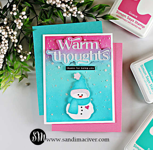 Handmade winter card featuring a bundled snowman die cut wearing a teal hat and scarf on a pink, purple, and teal ink-blended background. The card includes a layered “Warm Thoughts” sentiment at the top, a small “thanks for being you” label, and glitzy falling snow accents scattered across the background.