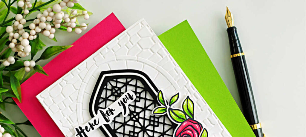 Handmade white A2 card featuring the Altenew Enchanted Castle Window 3D Embossing Folder and Gothic Arches Die Set, layered with a black lattice window over a stone-embossed background. A pink Bamboo Rose floral cluster with bright green leaves accents the lower right corner, and a “Here for you” sentiment is placed across the arch.