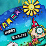 Colorful MemoryDex birthday card featuring a blue-to-teal ink blended background with splatter detail, festive banner flags, and a smiling sun. A cute girl in a party hat holds a birthday cake with candles beside a fluffy white dog, surrounded by bright flowers and green grass. The sentiment “Happy Birthday” appears on black labels in the center.