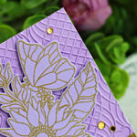 Lavender tone-on-tone handmade card featuring a large gold heat-embossed floral image from the Simon Says Stamp “Make My Heart Flutter” set. The layered flower and butterflies are outlined in gold on purple cardstock, set over an embossed geometric background with a brushed gold sentiment strip reading “sending lots of love” and accented with gold gems.