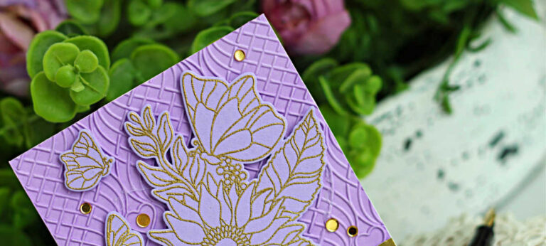 Lavender tone-on-tone handmade card featuring a large gold heat-embossed floral image from the Simon Says Stamp “Make My Heart Flutter” set. The layered flower and butterflies are outlined in gold on purple cardstock, set over an embossed geometric background with a brushed gold sentiment strip reading “sending lots of love” and accented with gold gems.