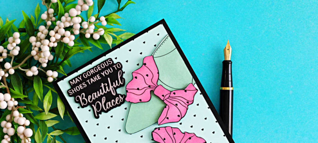Handmade card featuring Alex Syberia Designs Bow Shoes BetterPress plates with seafoam green shoes and pink bows on a tiny black heart foiled background, finished with a silver foiled “May gorgeous shoes take you to beautiful places” sentiment.
