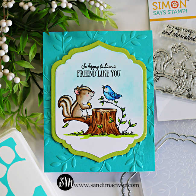 Handmade “Friend Like You” card featuring a Copic-colored squirrel and blue bird sitting on a tree stump, framed with a teardrop-shaped die cut and layered on a teal leaf-embossed background created with a 3D embossing folder.