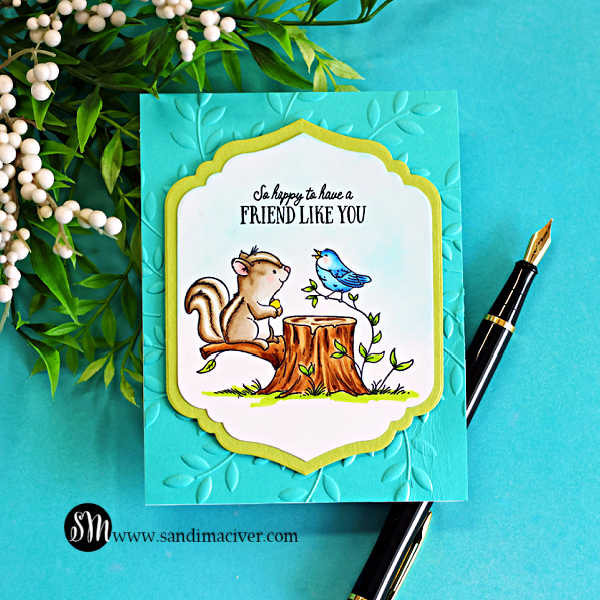 Handmade card featuring a Copic colored squirrel and blue bird sitting on a tree stump with the sentiment “So happy to have a friend like you,” layered on a teal embossed leaf background using an embossing folder and framed with a decorative die cut.