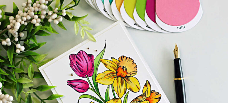 Handmade spring floral card featuring bright pink tulips and yellow daffodils created with the Spellbinders Yana’s Tulips BetterPress and Stencil Set. The flowers are colored with coordinating layering stencils and Prismacolor pencils on a white card panel and finished with a black and gold “Sending a bouquet of hugs” sentiment.