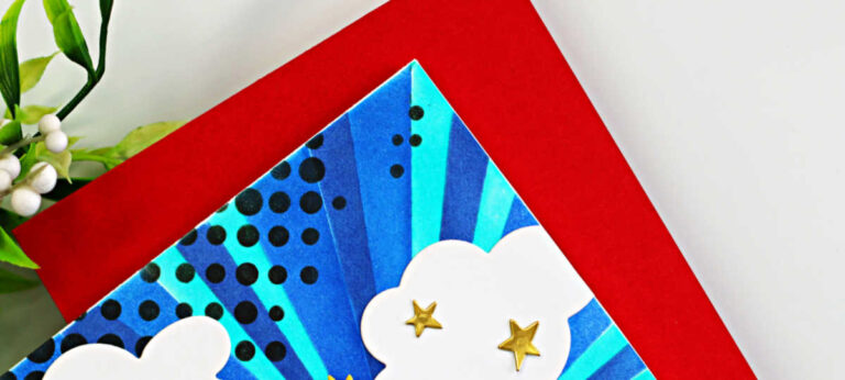 Handmade superhero-themed greeting card featuring a stylized Wonder Woman–inspired die-cut figure with a red cape and blue outfit standing against a vibrant blue burst background created with layered stencils. The background radiates with teal and navy rays and black halftone dots, with white clouds and small gold stars scattered around. A red banner at the bottom reads “YOU ARE SUPER.” Card created with the Spellbinders Small Die of the Month Unstoppable and the Burst Mode Layering Stencil of the Month.