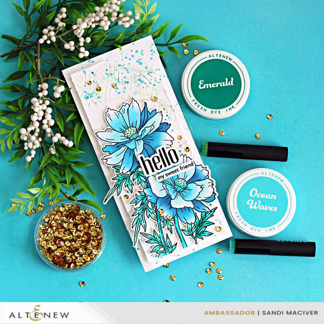 Slimline card featuring Altenew Sulfur Cosmos with layered stenciling, white relief paste texture, blue ink splatter, and coordinating dye inks on a turquoise background