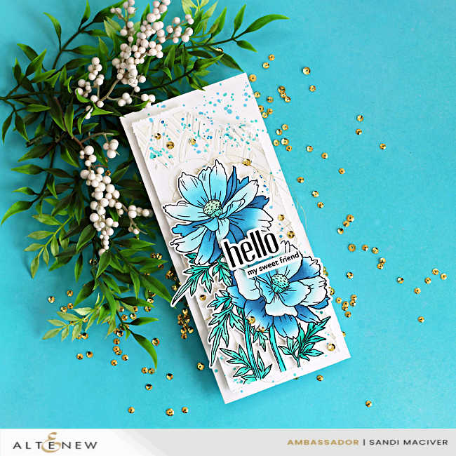 Finished mixed media slimline card featuring Altenew Sulfur Cosmos with layered stenciling, white relief paste background, and blue ink splatter