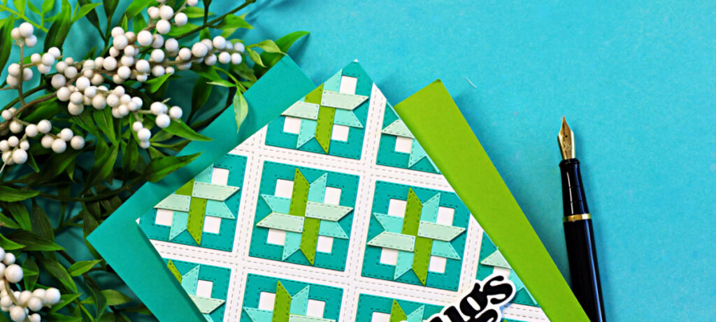 Flat lay of a teal and green die cut quilt card made with Altenew Patchwork Pathways dies, featuring a geometric cardstock pattern with white lattice background and “hugs” sentiment.