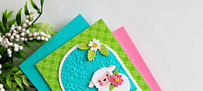 Handmade Easter lamb card created with the Simon Says Stamp Sweet Sheep die and A2 Arches dies, featuring a white sheep holding a flower on an embossed turquoise arch background with daisies and green patterned paper.