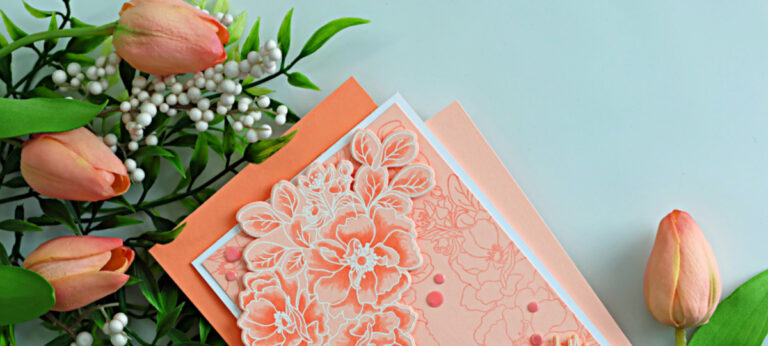 Monochromatic sympathy card featuring Wild Rose florals with white heat embossing and soft apricot Copic coloring, styled with tulips and greenery