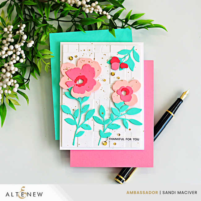 Blush and teal handmade card featuring layered die cut flowers, embossed background, gold splatter accents, and Altenew Botanical Waltz dies