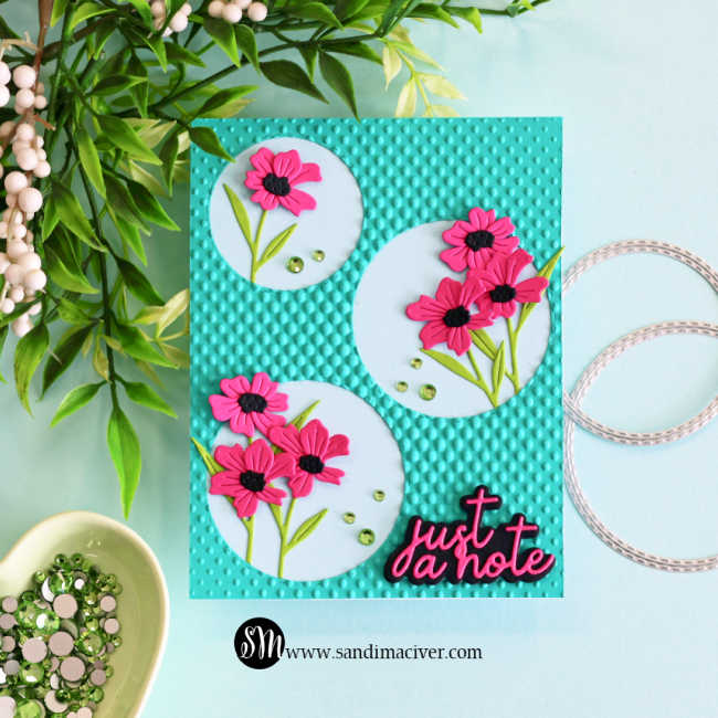Clean and simple die cut floral card featuring pink flowers inside stitched circle frames on a teal halftone embossed background with “just a note” sentiment and green embellishments.