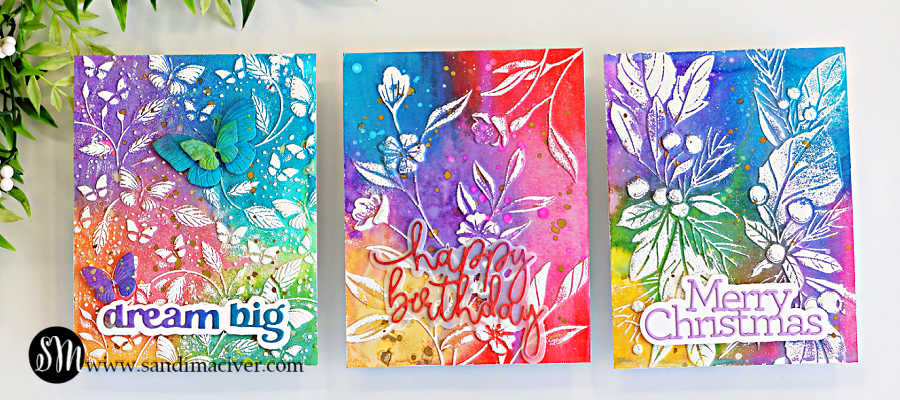 Three handmade cards created with an embossing folder technique for cardmaking, featuring vibrant Distress Oxide ink backgrounds, white heat embossed designs, and sentiments including “Dream Big,” “Happy Birthday,” and “Merry Christmas.”