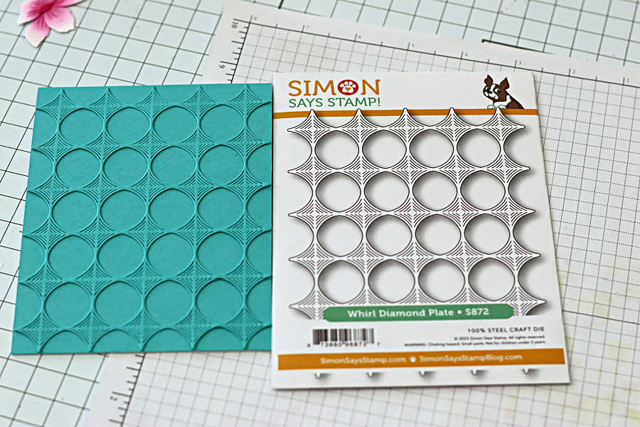 Embossed teal background using Whirl Diamond Plate die for a die cut spring card.