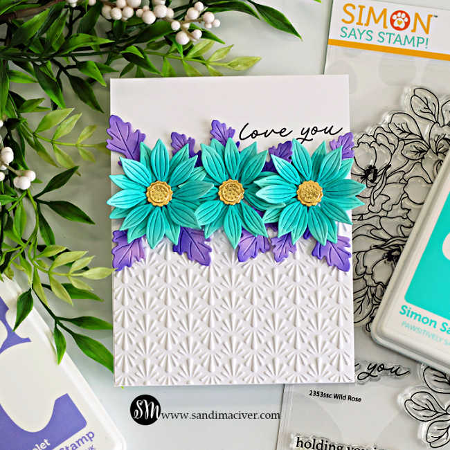 Clean and simple floral card with teal layered flowers and purple leaves across the top, tone-on-tone embossed white background on the bottom, and “love you” sentiment, demonstrating embrace the white space cardmaking design.