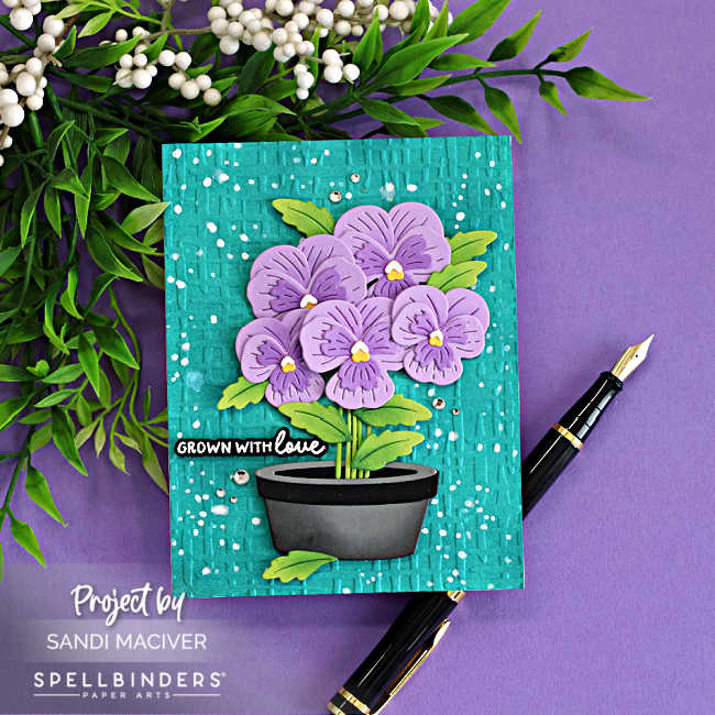 Fresh Packed floral card featuring die cut pansy flowers in a pot, embossed Market Weave background, and ink splatter using Spellbinders Small Die of the Month