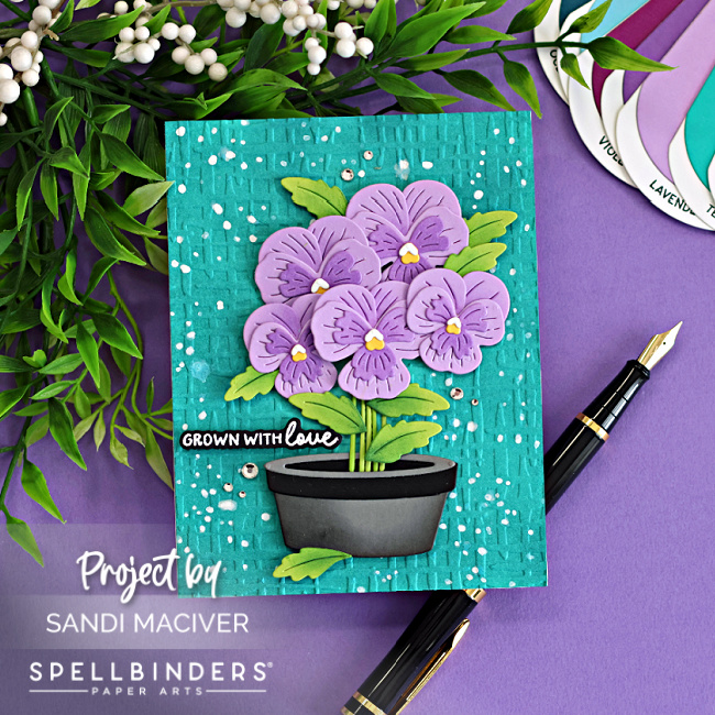 Fresh Packed floral card with layered die cut pansies, embossed Market Weave background, ink splatter and potted flowers using Spellbinders dies